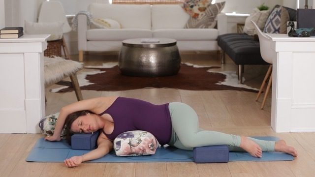 A women do restorative yoga
